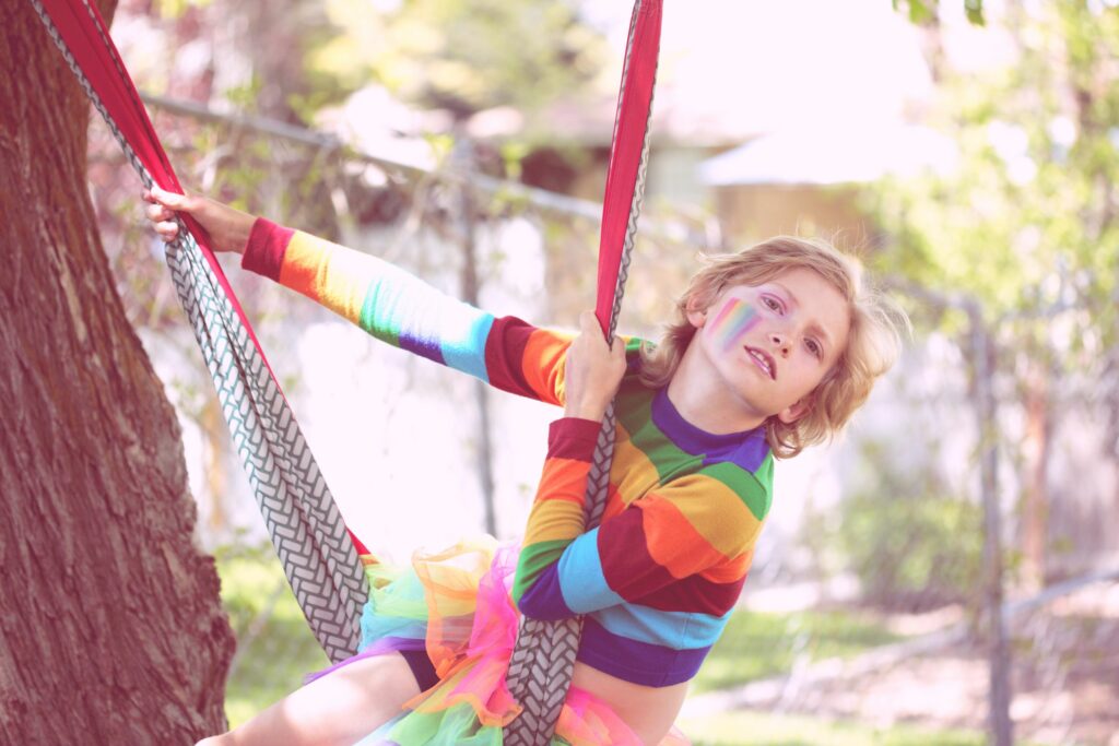 transgender child on a swing rainbow