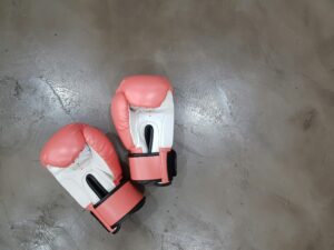 A set of red boxing gloves on the ground