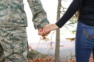 A miliary veteran and their spouse holding hands