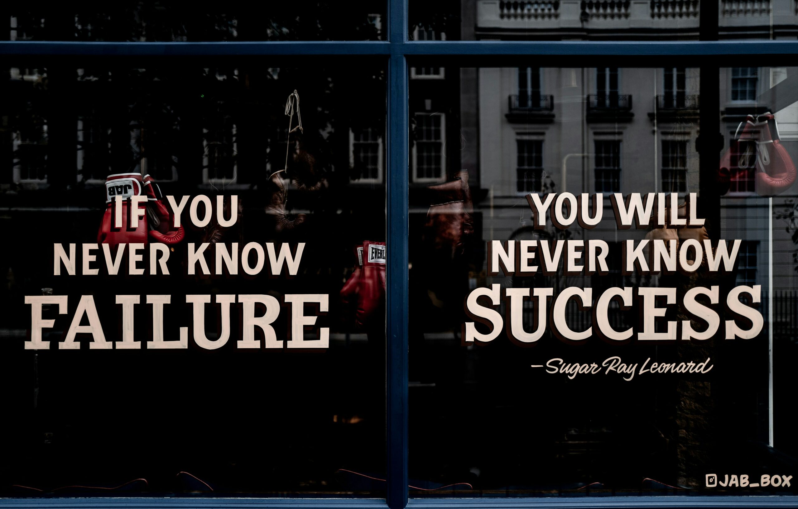 Windows with the words "If you never know failure you will never know success" printed on them