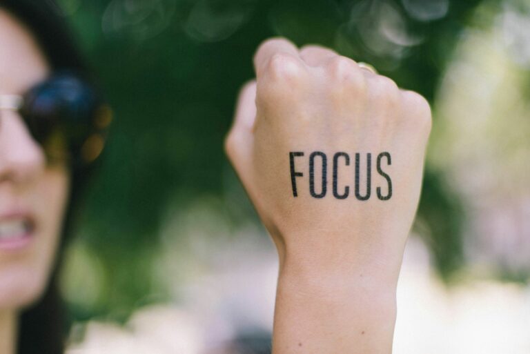 person holding hand up and it says focus