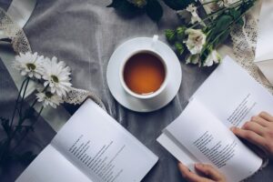 a warm drink with books and flowers to help the individual relax and concentrate