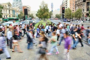 A blurred image of a crowd, conveying how it can feel to be swallowed up of feelings of otherness and being alone even when there are many other people around you. 