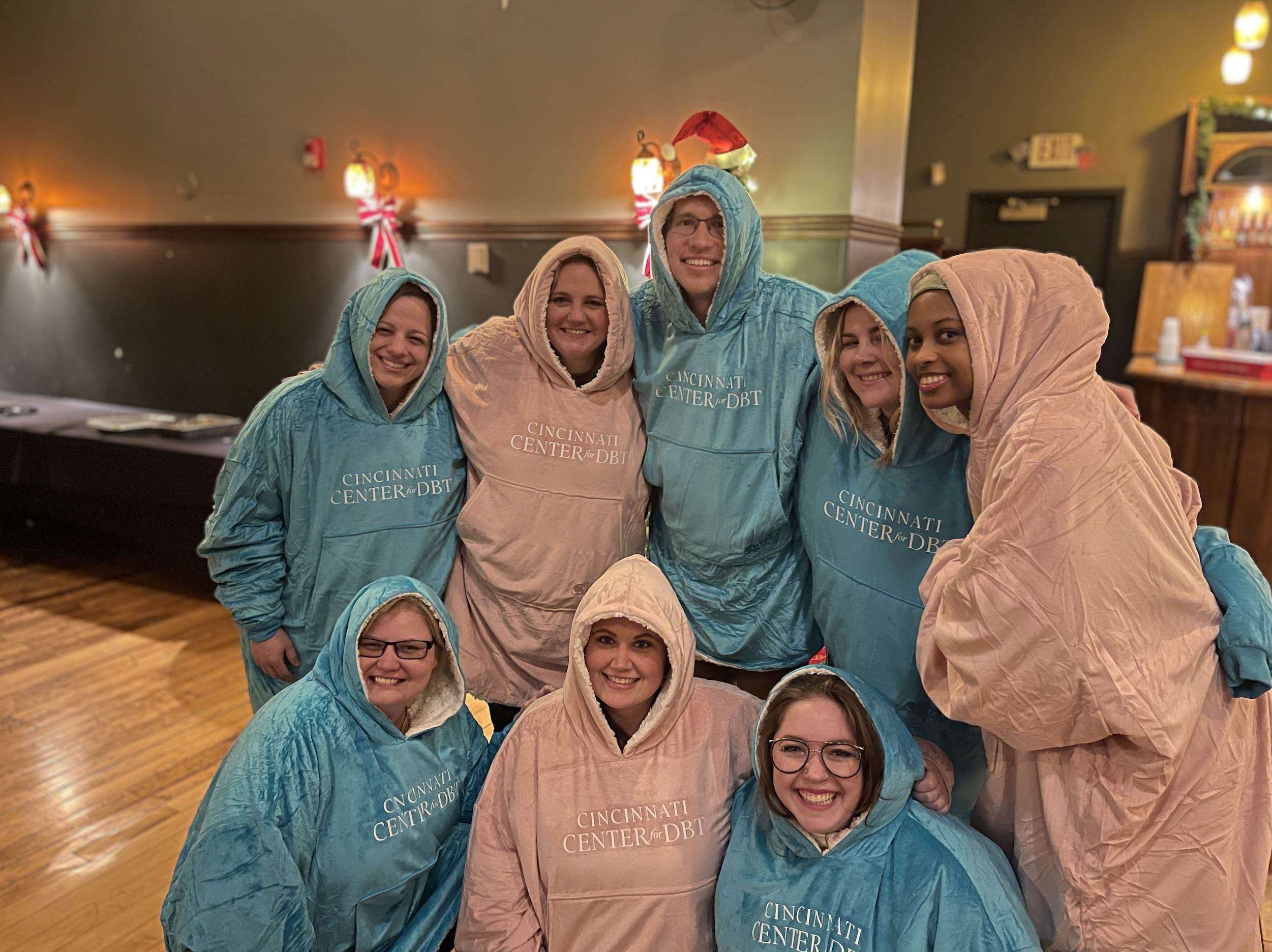 Cincinnati Center for DBT staff dressed in pink and blue Snuggies welcoming you to our office