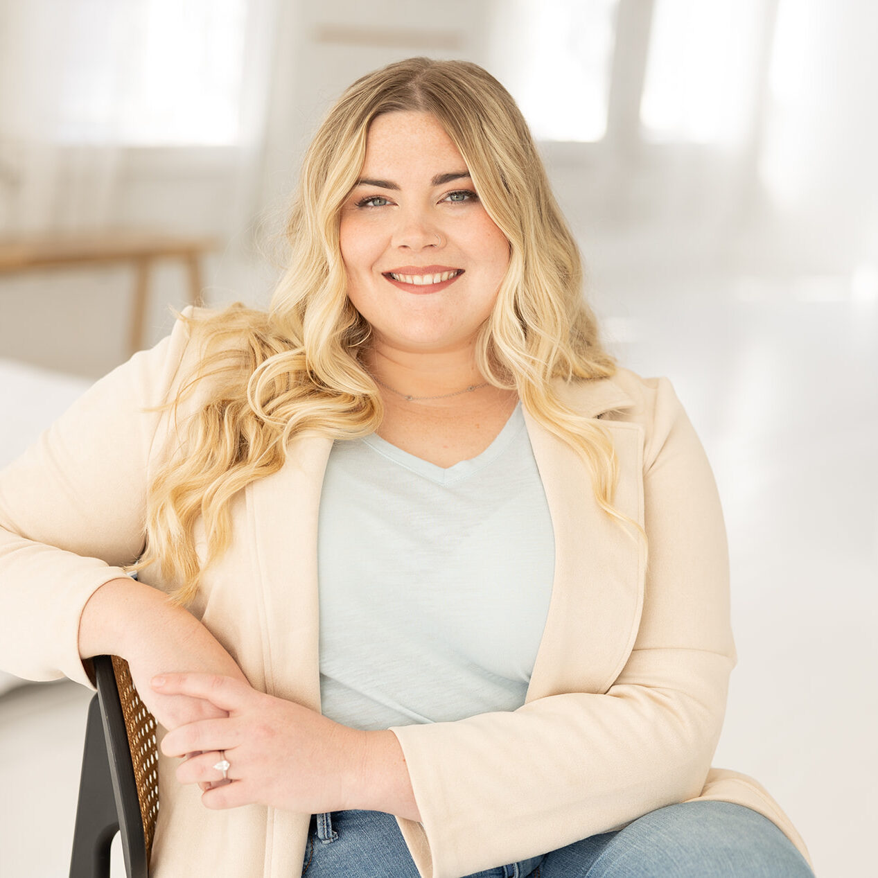 Cincinnati Center for DBT Therapist Eleanor Raker sits in chair and smiles at camera